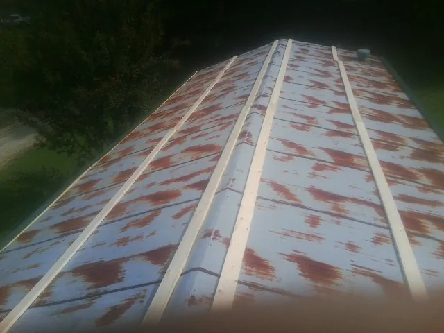 Rusted metal roof panels with new wood purlins before replacement — Storm Damage Roof Repair in Marlow by Roofing Brothers